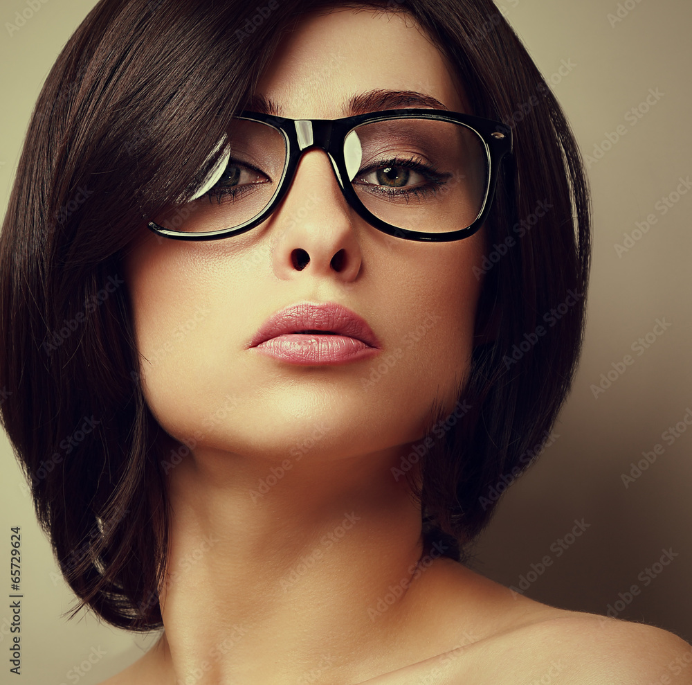 Beautiful makeup fashion girl in modern glasses looking Beautiful makeup fashion girl in modern glasses looking
