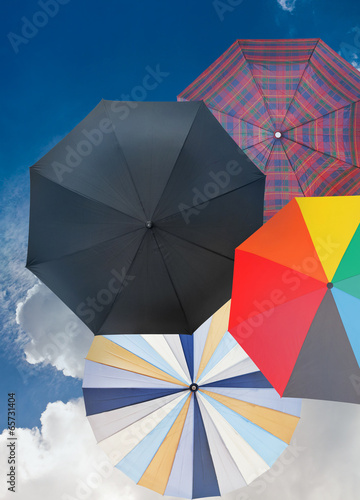 four different open umbrellas with dark blue sky