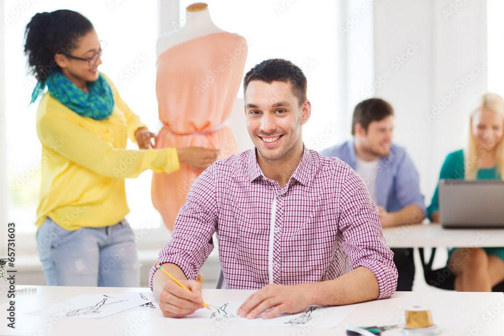 smiling fashion designers working in office smiling fashion designers working in office