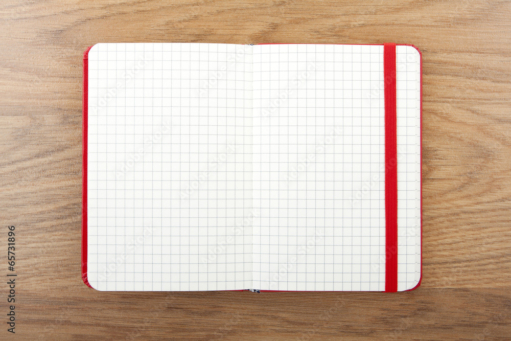Notebook with elastic band on wooden background. Notebook with elastic band on wooden background.