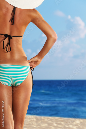 Close-up of slim woman on the sea beach