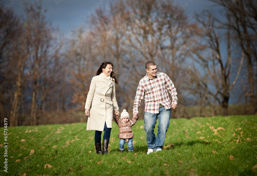 Family relaxing together in autumn nature