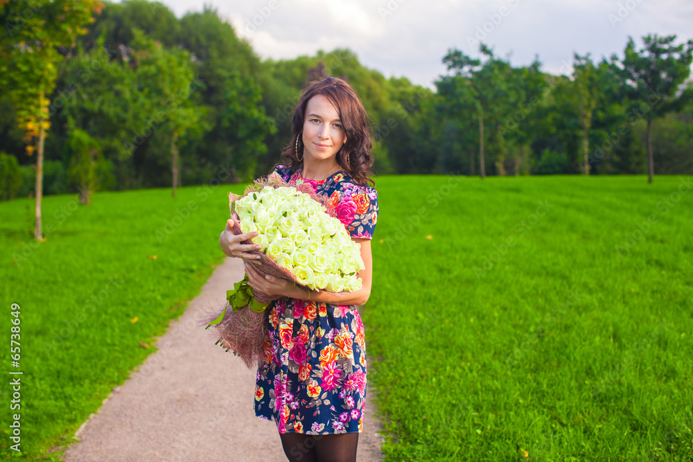 Beautiful young woman with big bouquet of white roses Beautiful young woman with big bouquet of white roses