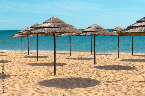 Blue sky  blue sea and parasols at  beach in Portugal