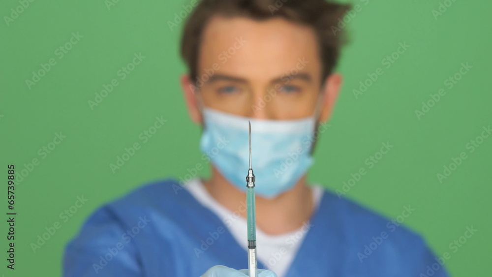 Doctor or male nurse with a hypodermic Doctor or male nurse with a hypodermic