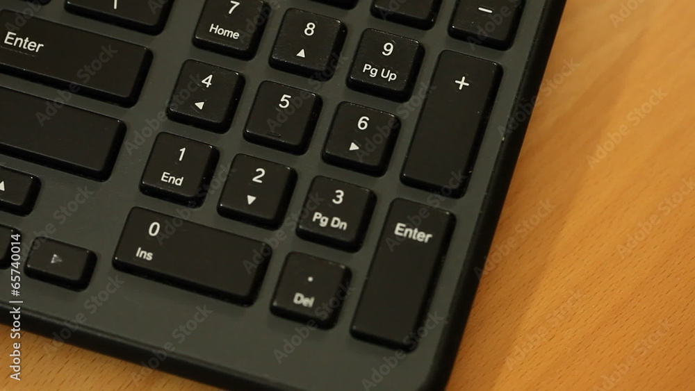 Finger pressing numbers buttons on keyboard Finger pressing numbers buttons on keyboard