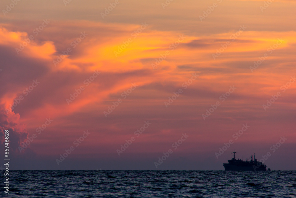 Container cargo ship at sunset, silhouette photo