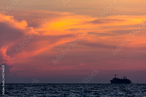 Container cargo ship at sunset, silhouette photo