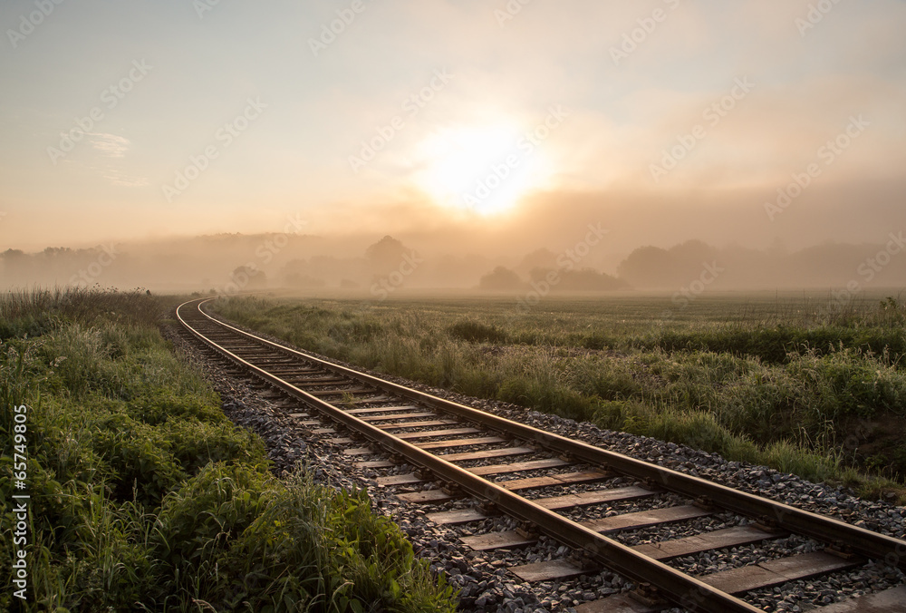 Fototapeta premium Track in misty landscape at sunrise