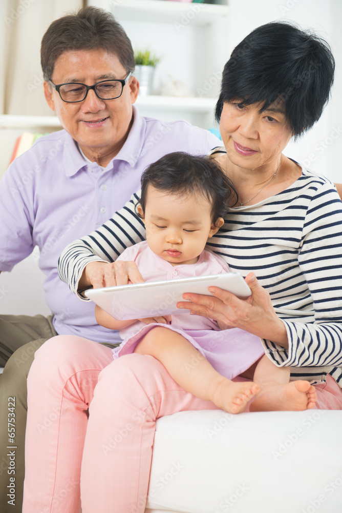 asian grand parents teaching grand son with tablet asian grand parents teaching grand son with tablet