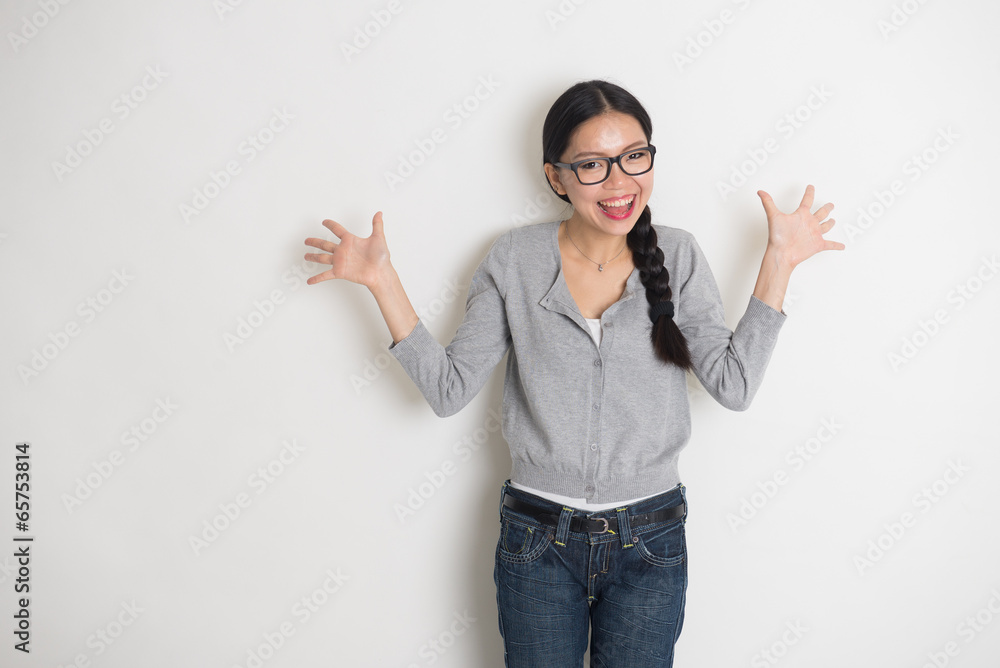 asian young female student in suprise look with plain background asian young female student in suprise look with plain background
