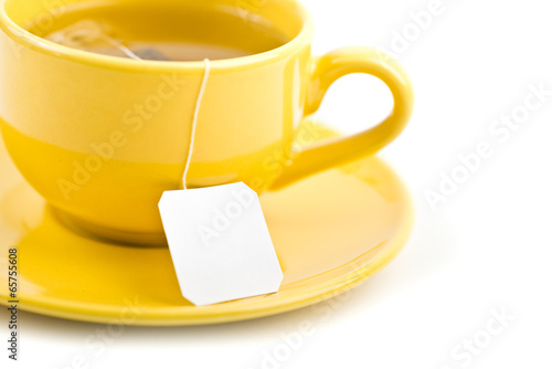 Cup of tea with tea bag (blank label) on white background