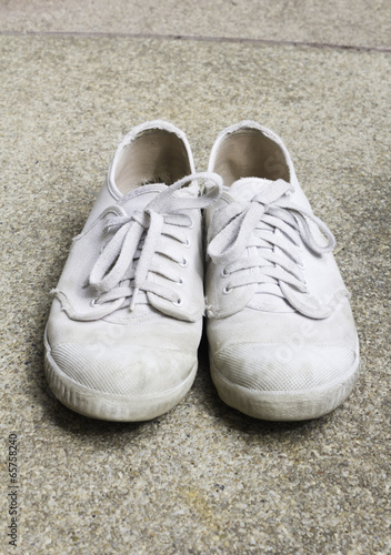 old sneakers on basically sand wash
