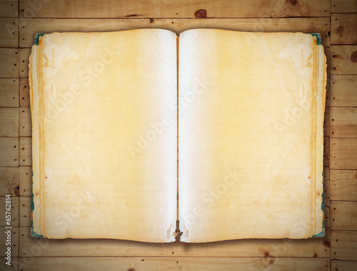 Vintage book on old wooden background clipping path. photo