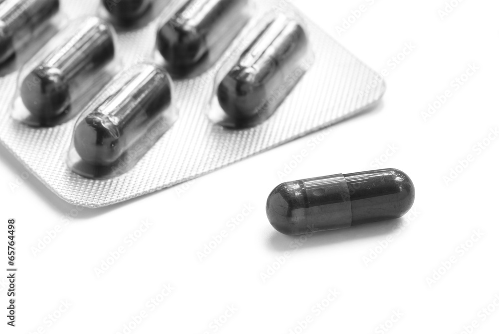 Activated carbon capsules isolated on white background Activated carbon capsules isolated on white background