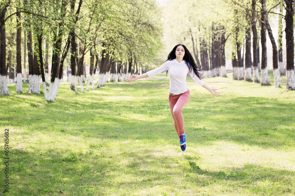 beautiful girl jumping in park