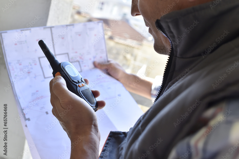 Entrepreneur on building site using walkie talkie Entrepreneur on building site using walkie talkie