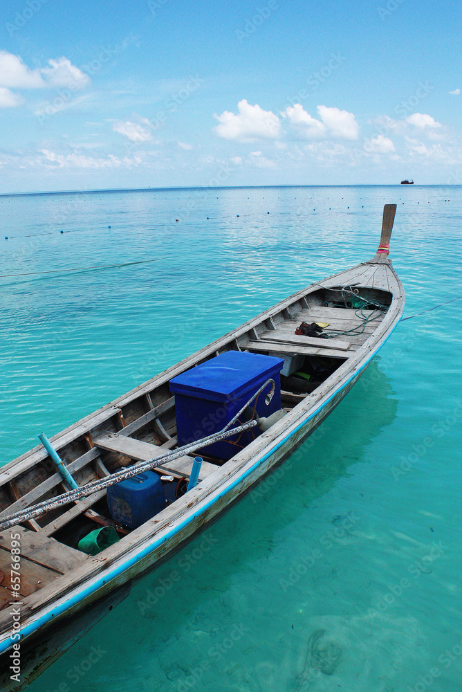 Wooden boat floating on clear water