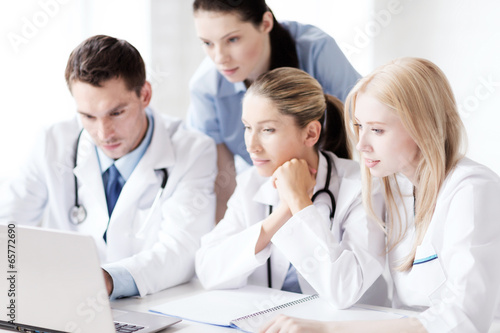 group of doctors looking at tablet pc