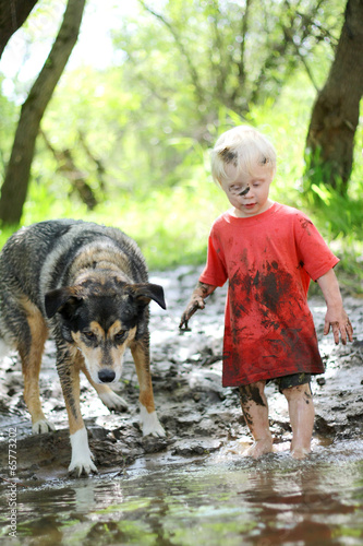 Young Child and Dog Playing in Muddy River