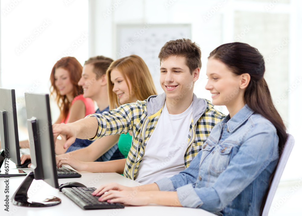 female student with classmates in computer class female student with classmates in computer class