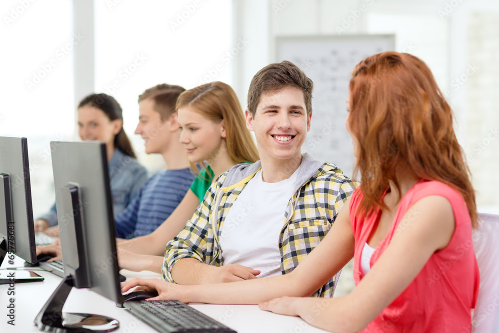 smiling students in computer class at school smiling students in computer class at school