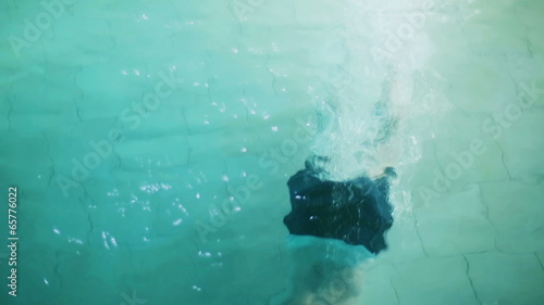 Man jumping to the pool at night photo