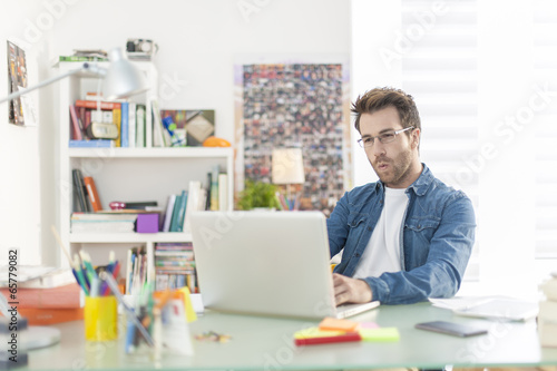 young man working on a laptop indoors