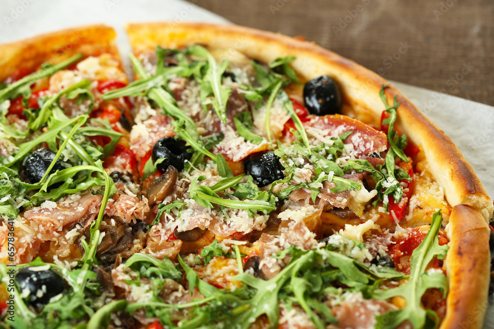 Pizza with arugula on color wooden background Pizza with arugula on color wooden background