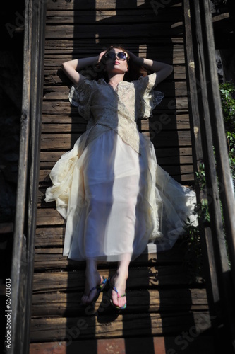 Girl lying on a bridge