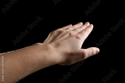 Human hand on black background