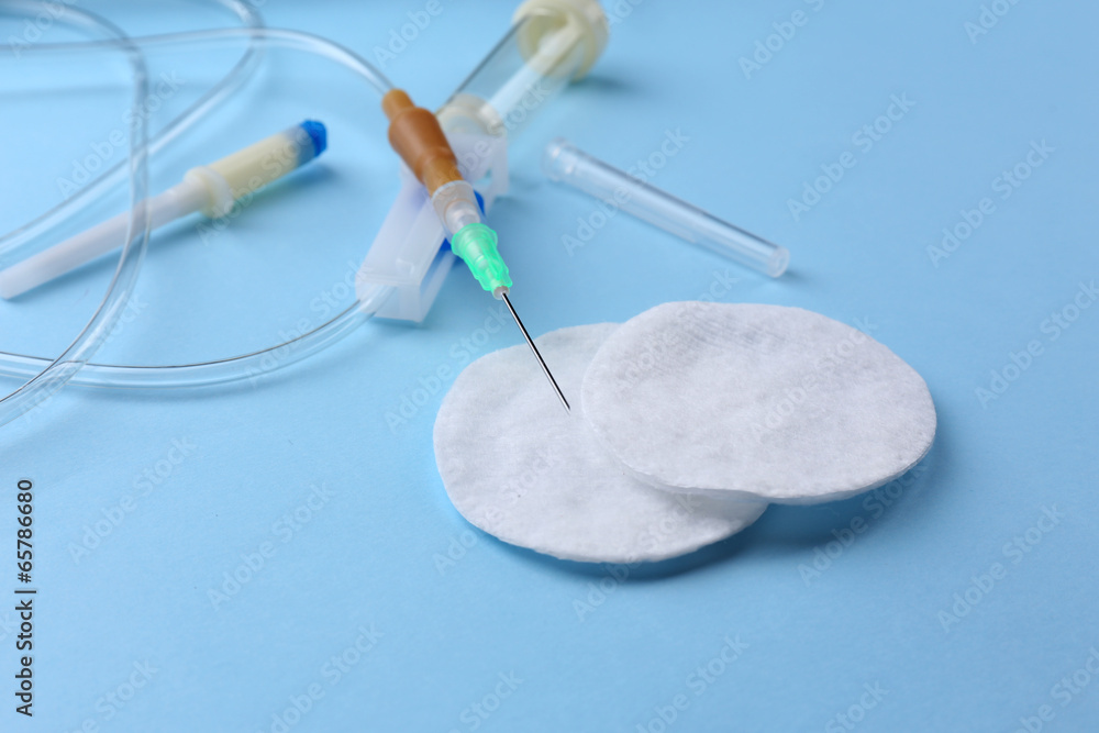 Disposable infusion set on blue background Disposable infusion set on blue background