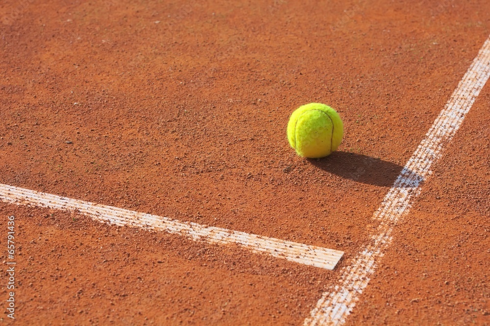 Tennis ball on corner of court.