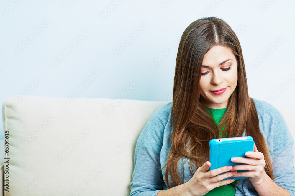 Young woman working with tablet pc, pad at home. Female model Young woman working with tablet pc, pad at home. Female model