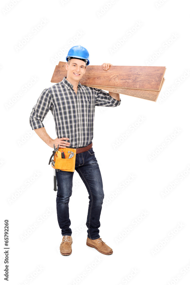 Construction worker holding a couple of planks Construction worker holding a couple of planks