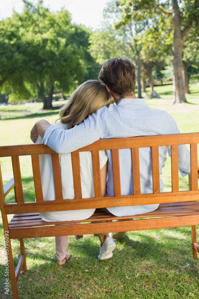 Couple relaxing on park bench together Couple relaxing on park bench together
