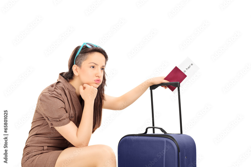 Sad female tourist holding a passport and waiting Sad female tourist holding a passport and waiting