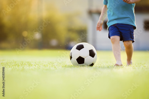 Little boy playing football
