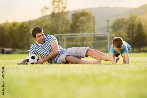 Father and son playing football