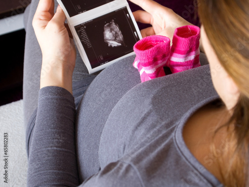 Pregnant woman with ultrasound image photo