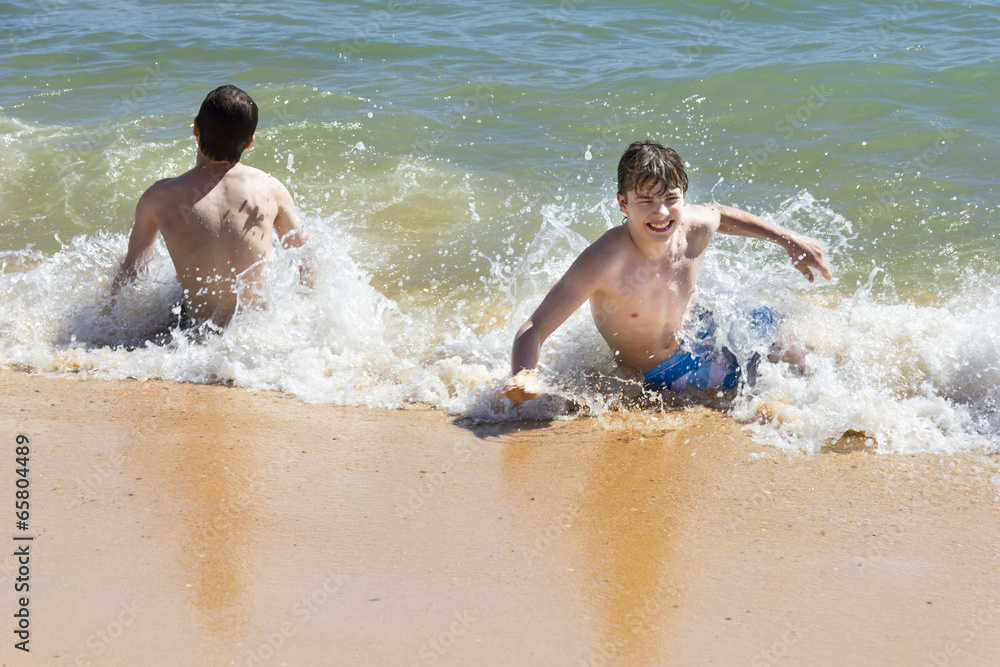 boys are playing in a beautiful sea with crystal clear water boys are playing in a beautiful sea with crystal clear water