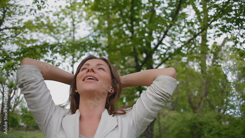 young, beautiful woman enjoying the fresh air in the forest