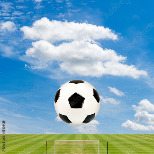 soccer ball with soccer field against  blue sky background