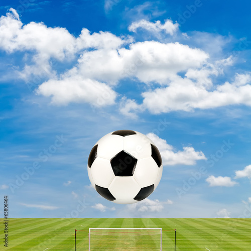 soccer ball with soccer field against  blue sky background © Satit _Srihin