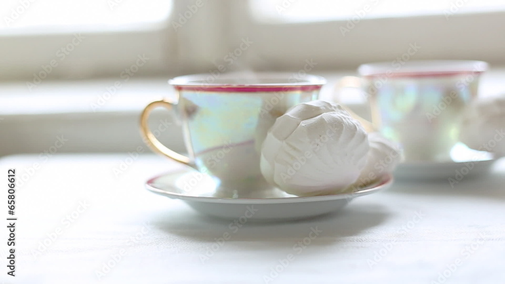 Two cups of hot tea and dessert on the table Two cups of hot tea and dessert on the table
