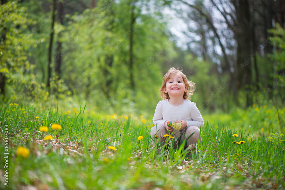 Little blonde girl in green grass Little blonde girl in green grass