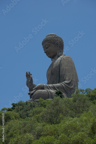 Three-quarter view of Big Buddha among trees