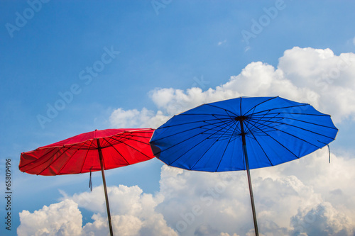 blue and red beach umbrella on blue sky background