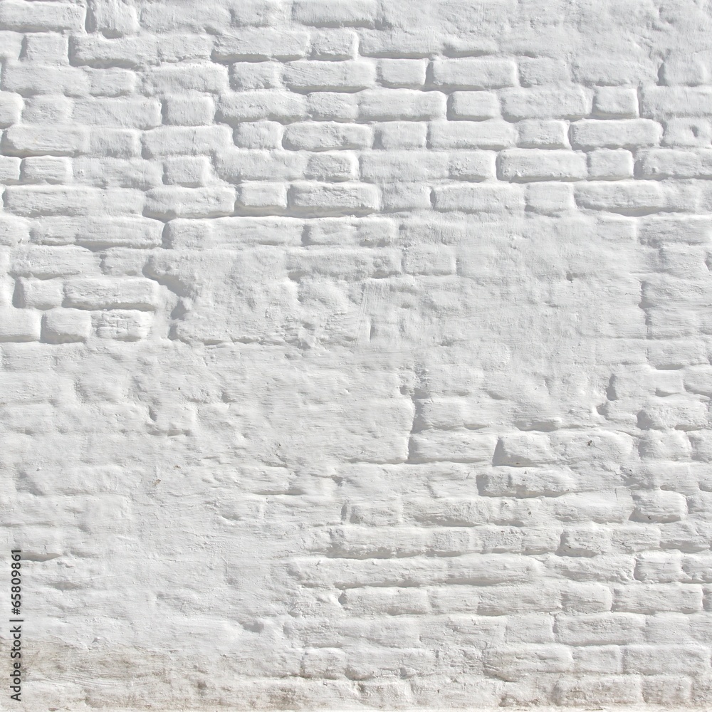 Naklejka premium White plastered brick wall