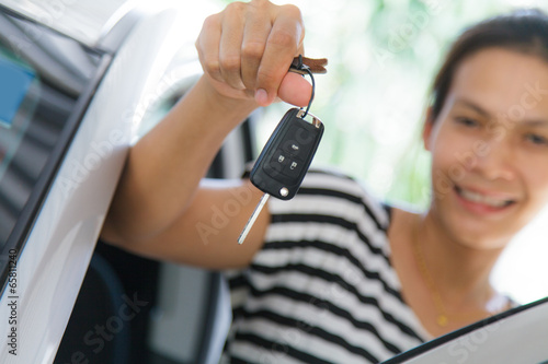 Woman holding a car key